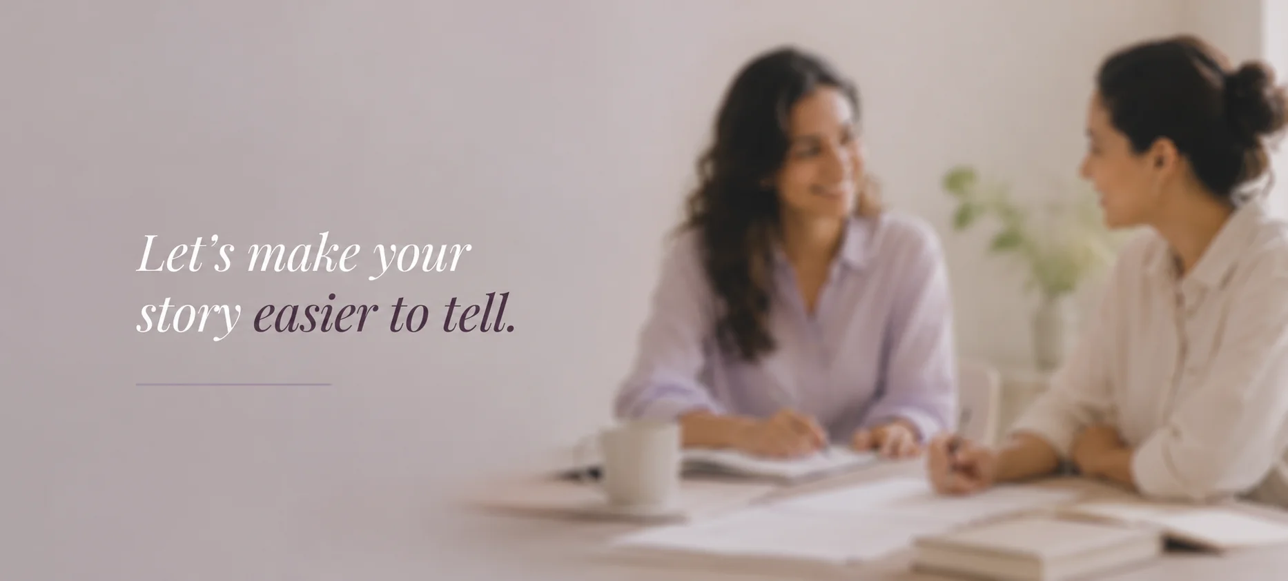 Two women in conversation across a table — Let's make your story easier to tell